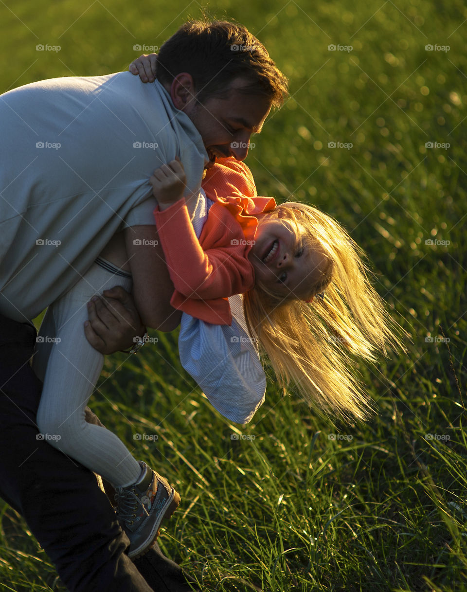 Happy father playing with daughter