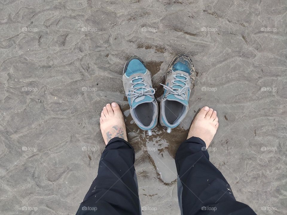 my trekking shoes are always with me and here I am cooling my feet in the sand on the beach