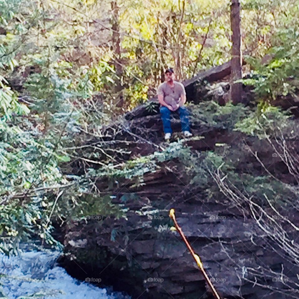 Man on the rocks !  Husband resting on top of the rocks catching a cool breeze in the partial shade while enjoying the sound of the raging water below. 