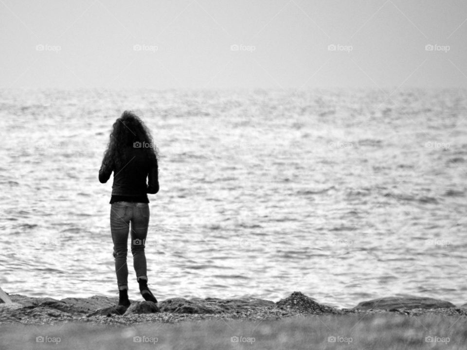 girl  on the seaside looking the sea