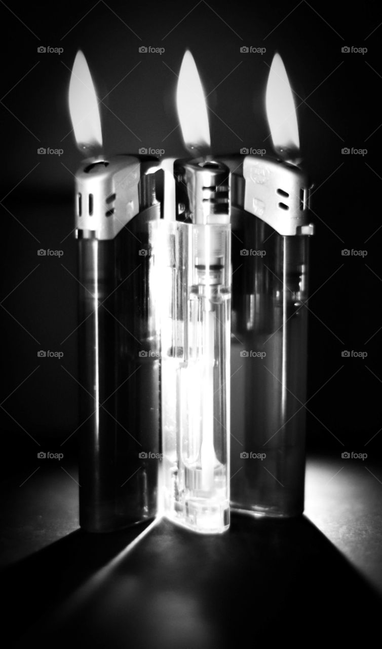 Three lighters with a flame