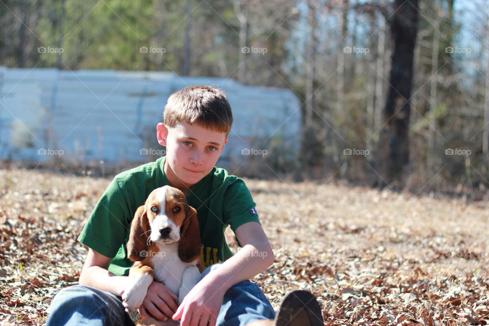 Boy with his Bassett Hound Puppy
