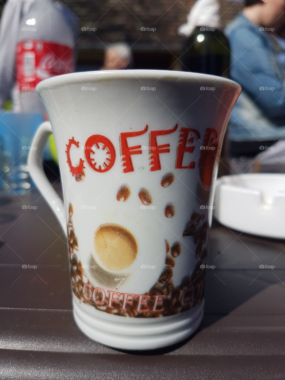 cup od coffee, label coffee on ceramic cup, photographed outdoors