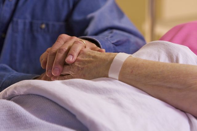 Husband comforting wife in hospital 