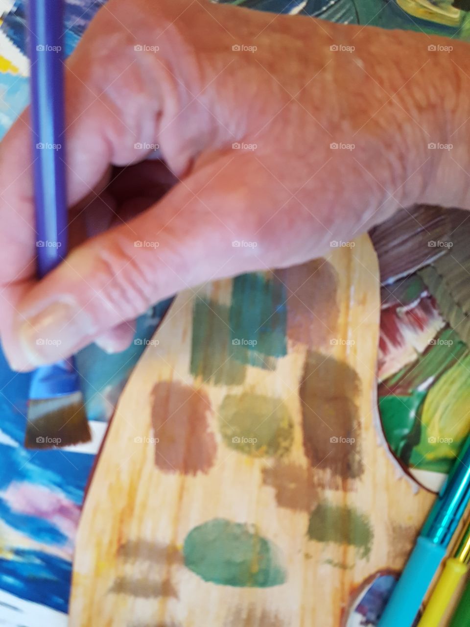 Close-up of a person holding paintbrush