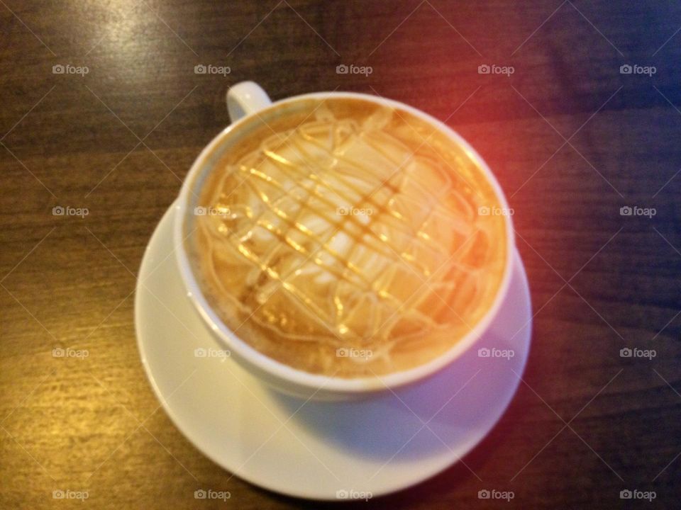 A Fancy Cappuccino at a Coffee Shop on a Coaster 