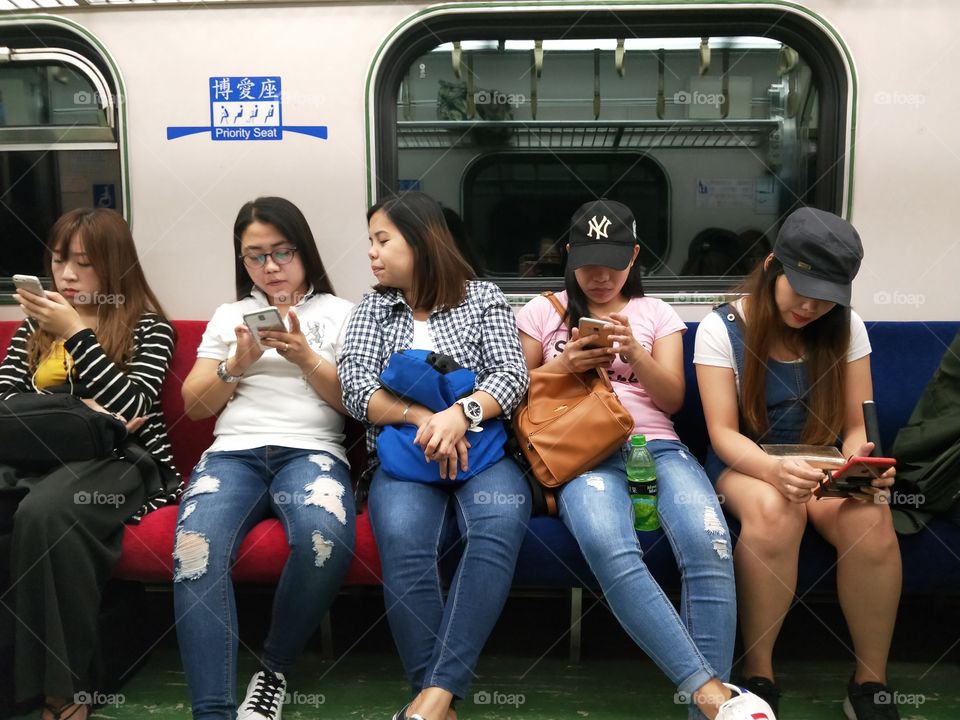 they are busy using smartphone while traveling