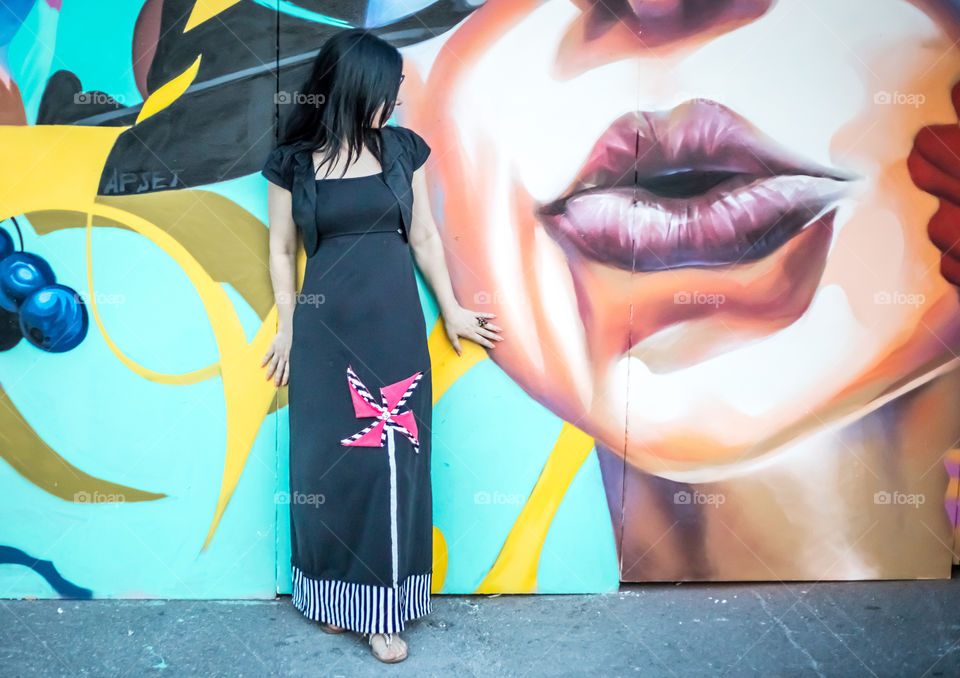 Young Woman In Front Of Graffiti Wall
