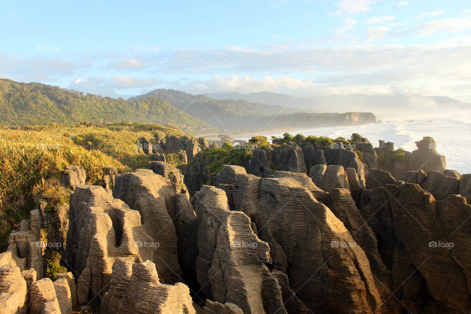 Scenic view of a pancake rocks against cloudy sky