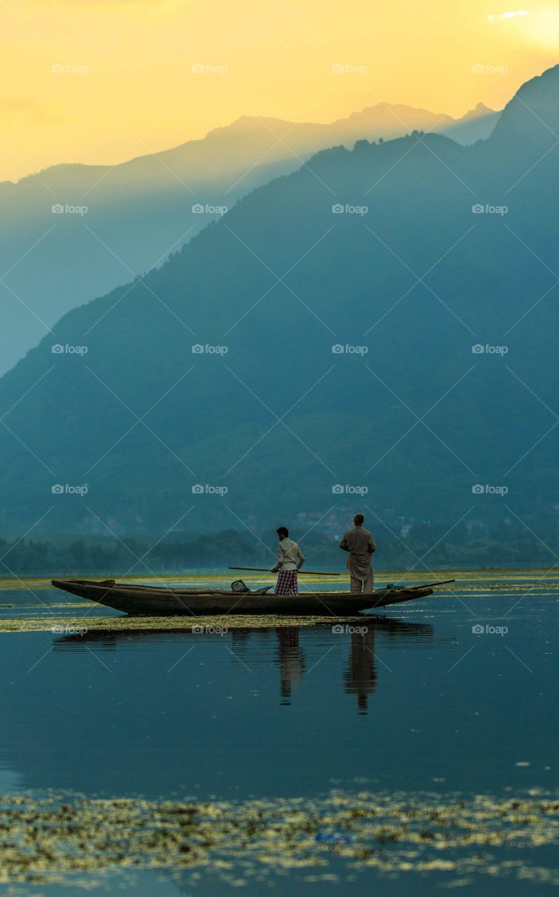 peaceful sailing by the lake below the mountain