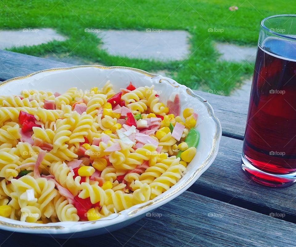 Pasta with drink on wooden table