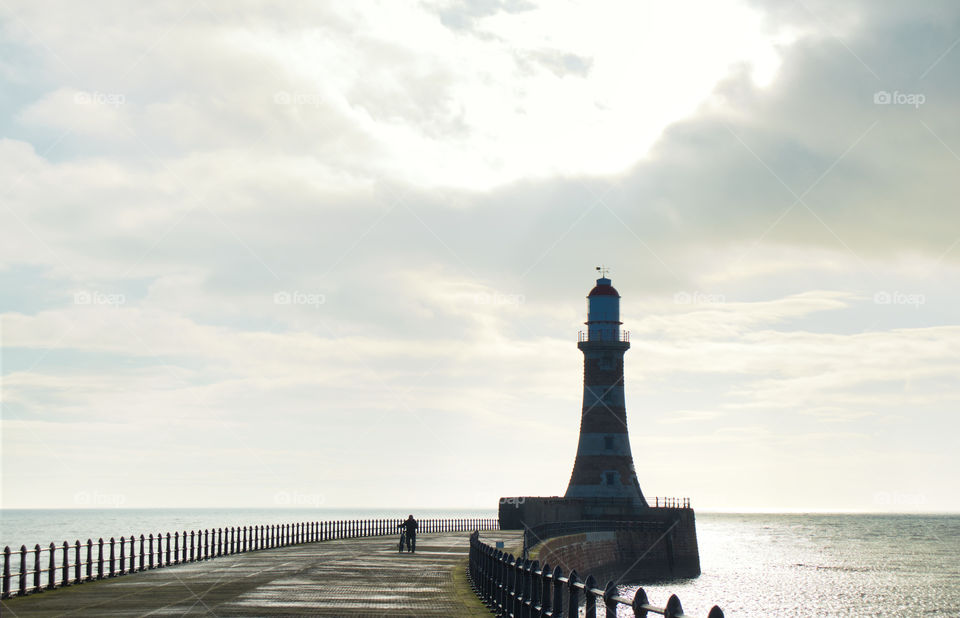 Roker lighthouse pier and old cyclist