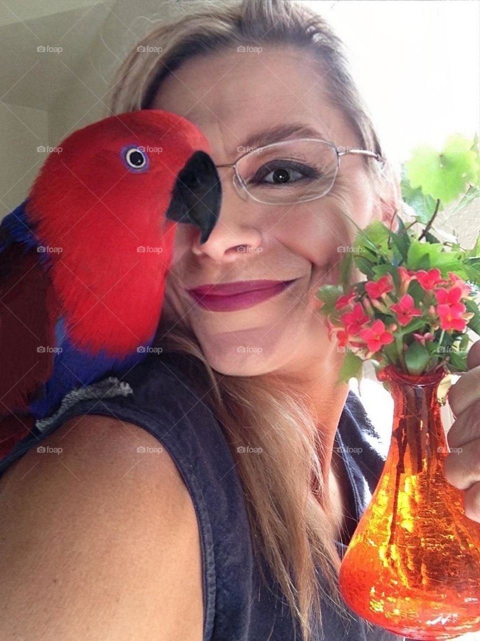 Woman and a Red parrot.