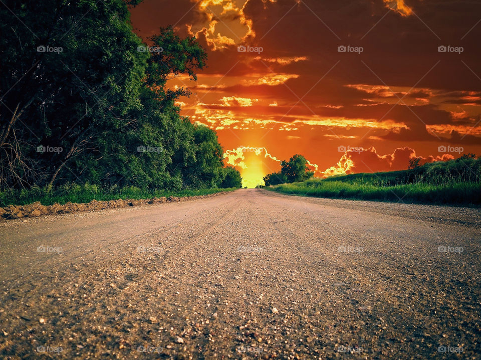 Scenic view of empty road against dramatic sky