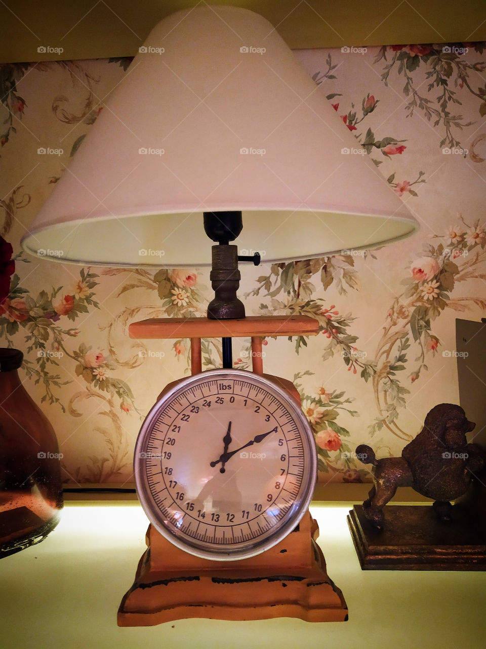 Lampshade with clock on the shelf