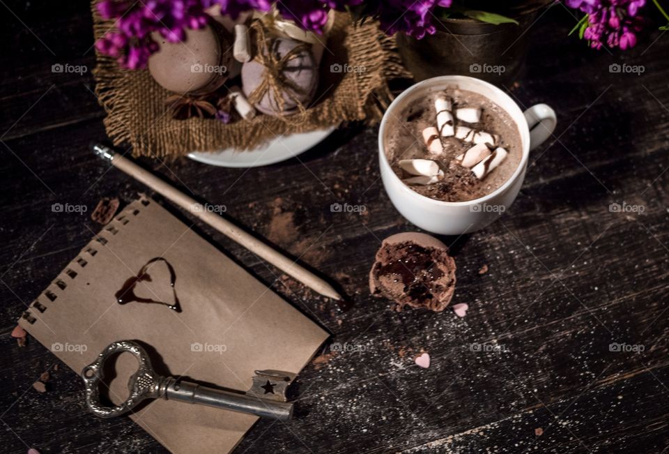 Hot chocolate with macaroons on a wood table 