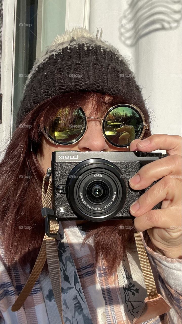 A photography picks up her camera and a pair of sunglasses, for a bit of fun in the cold. 