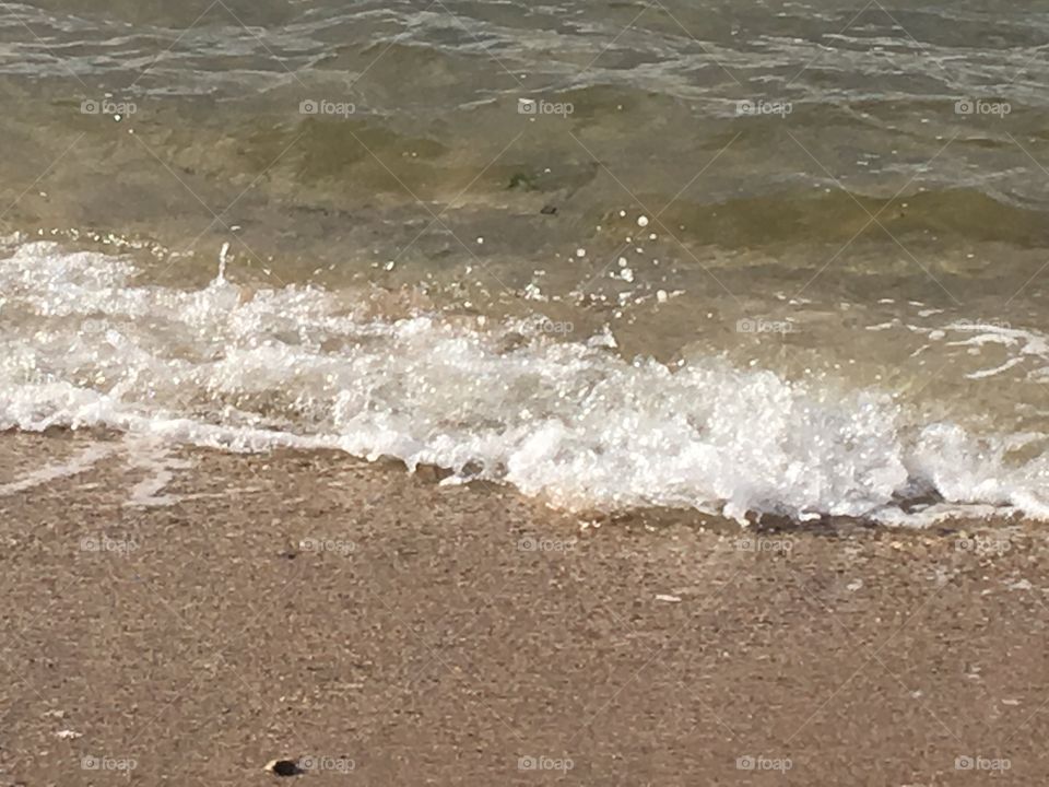 Moving waves crashing on the beach.