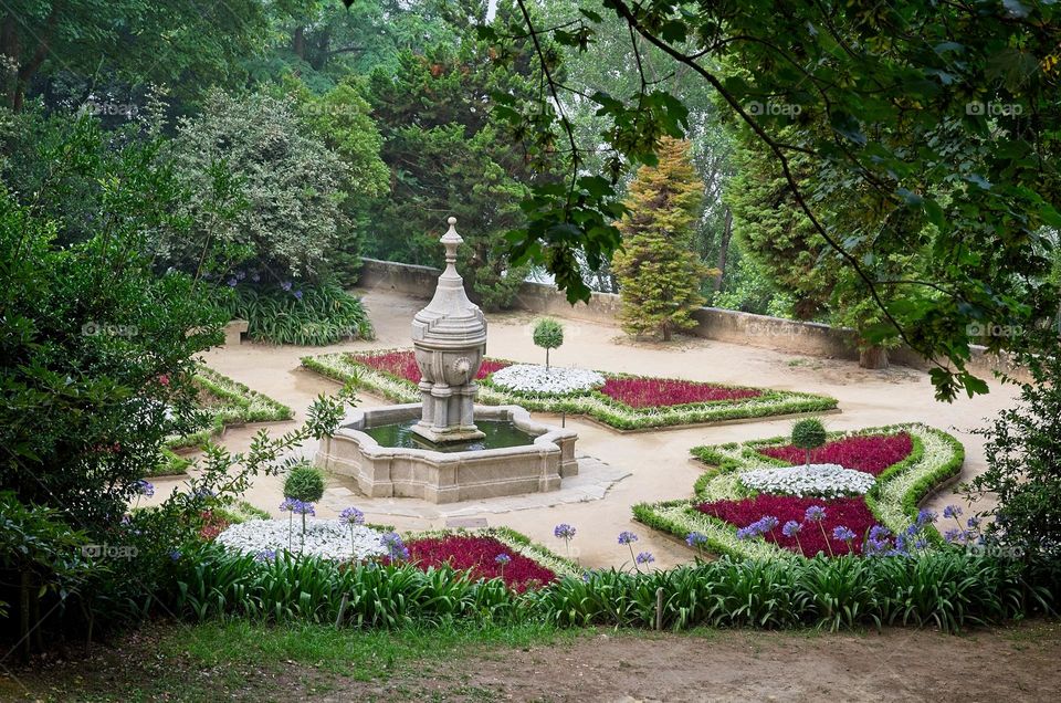 Beautiful park with a fountain surrounded by flowers