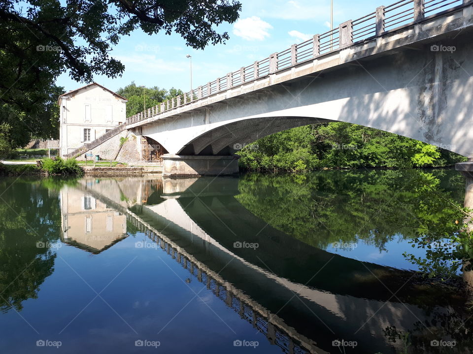 Bridge reflects in the river water