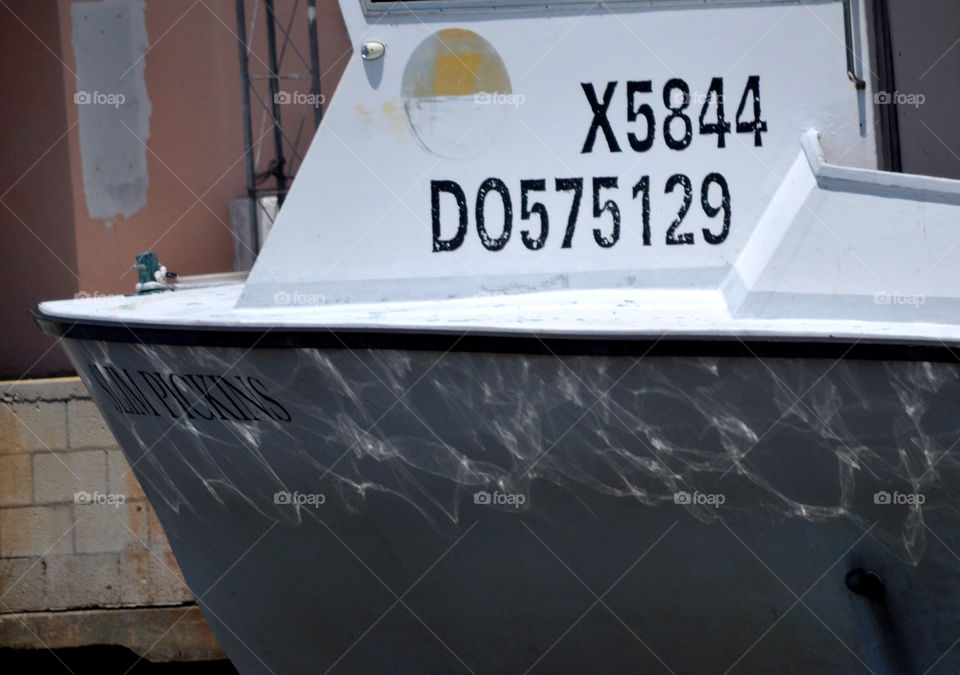 Water reflected on an old grey boat