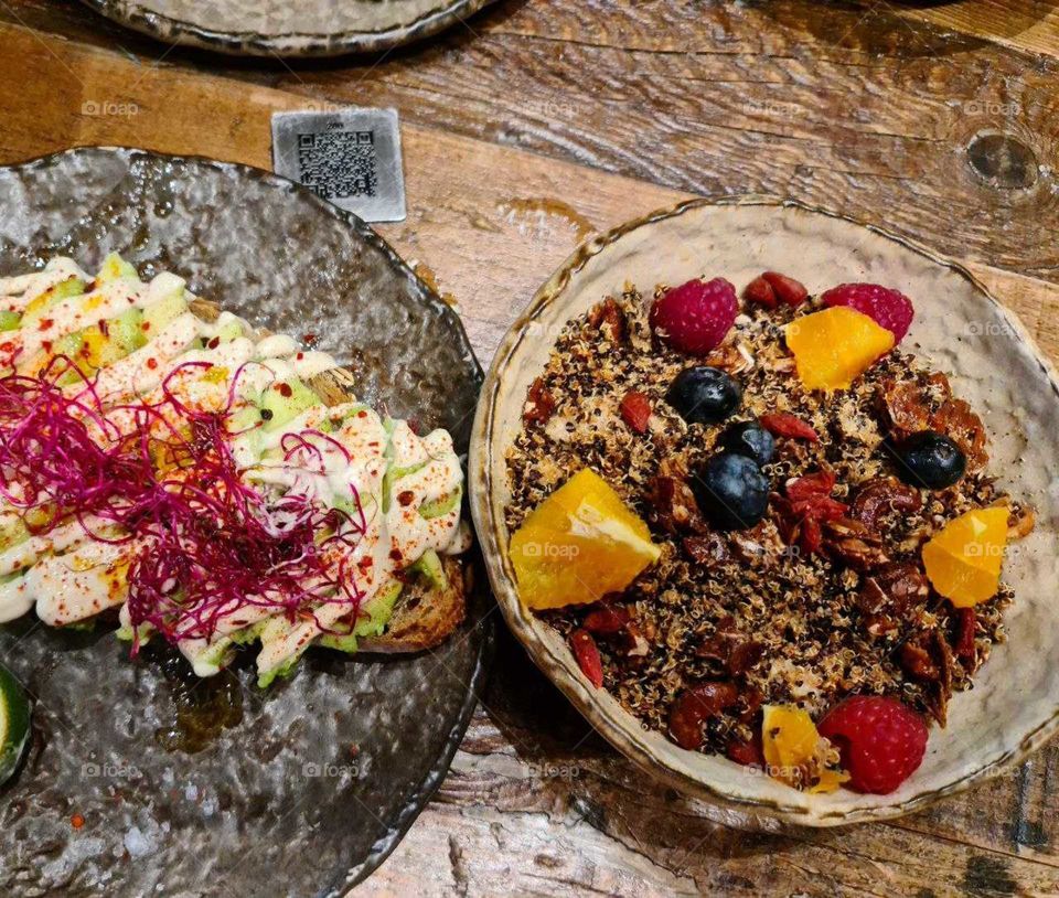 Plant based. Healthy food. Quinoa, walnuts, goji, orange, avocado, beetroot, cinnamon, raspberry.