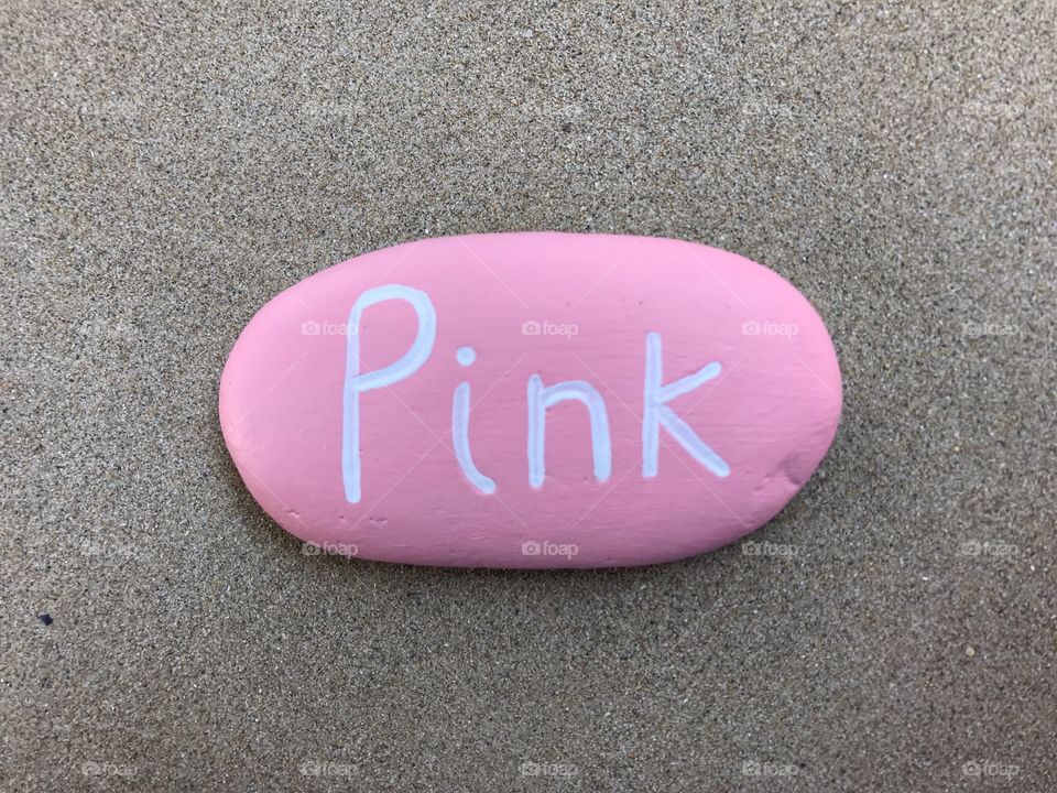 Pink stone on sand