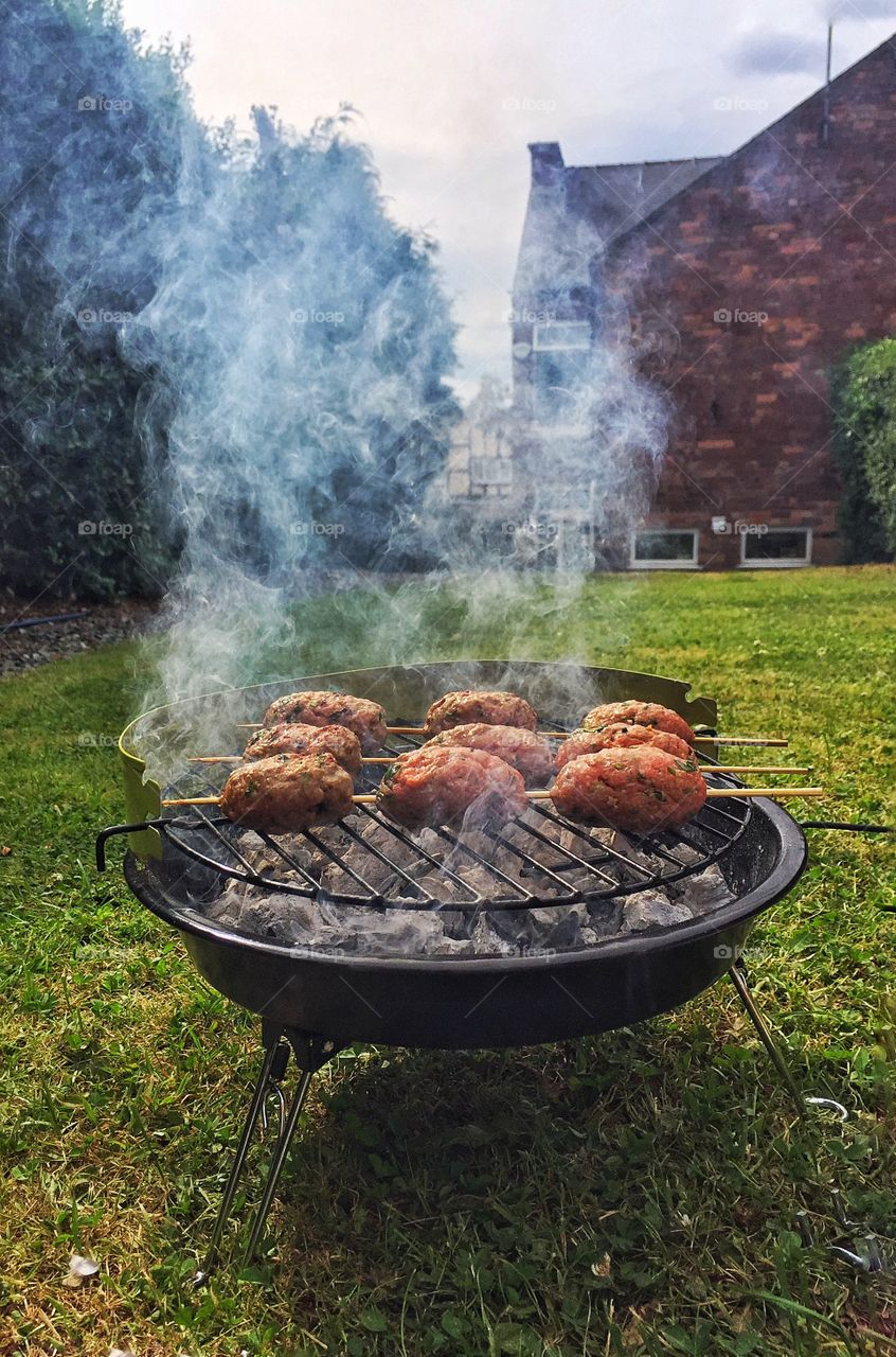 Cooking meat on barbecue grill