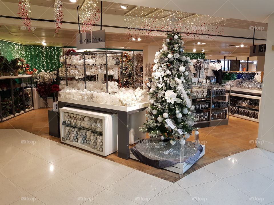 Christmas shop festive scene with decorated tree and white baubles at Peter Jones Sloane square Chelsea King's road London