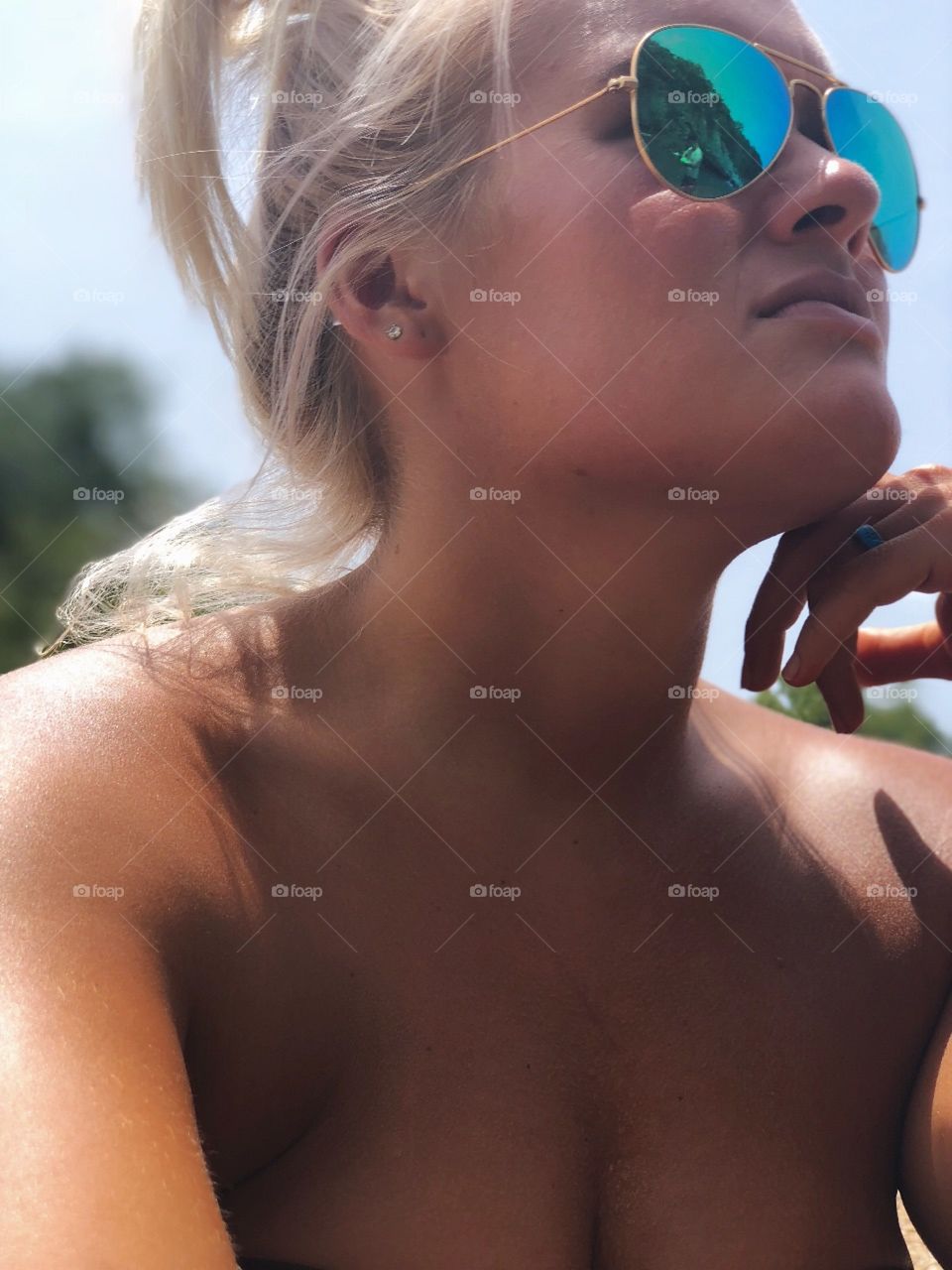 Raw natural lighting on this blonde beauty. No makeup fresh tanned skin on a canoe trip.
