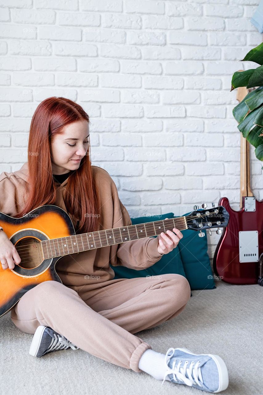 teen girl playing guitar