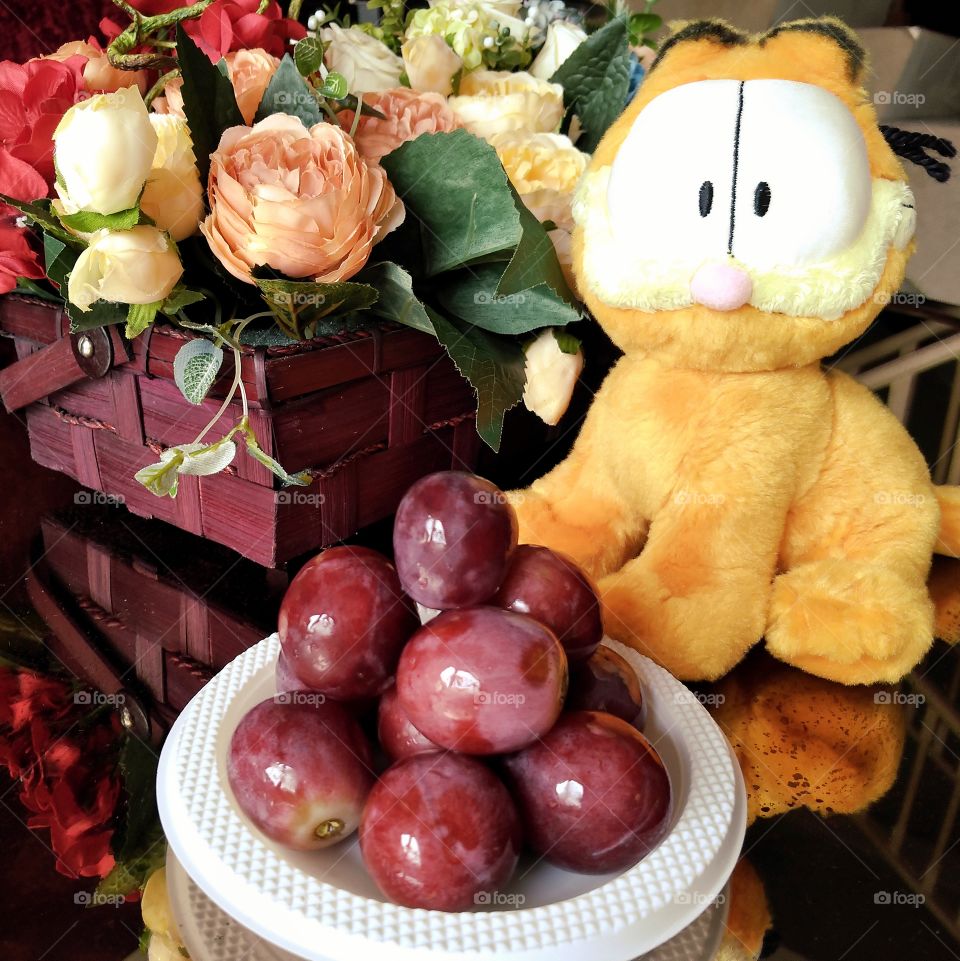 Red globe grapes, cat and flower