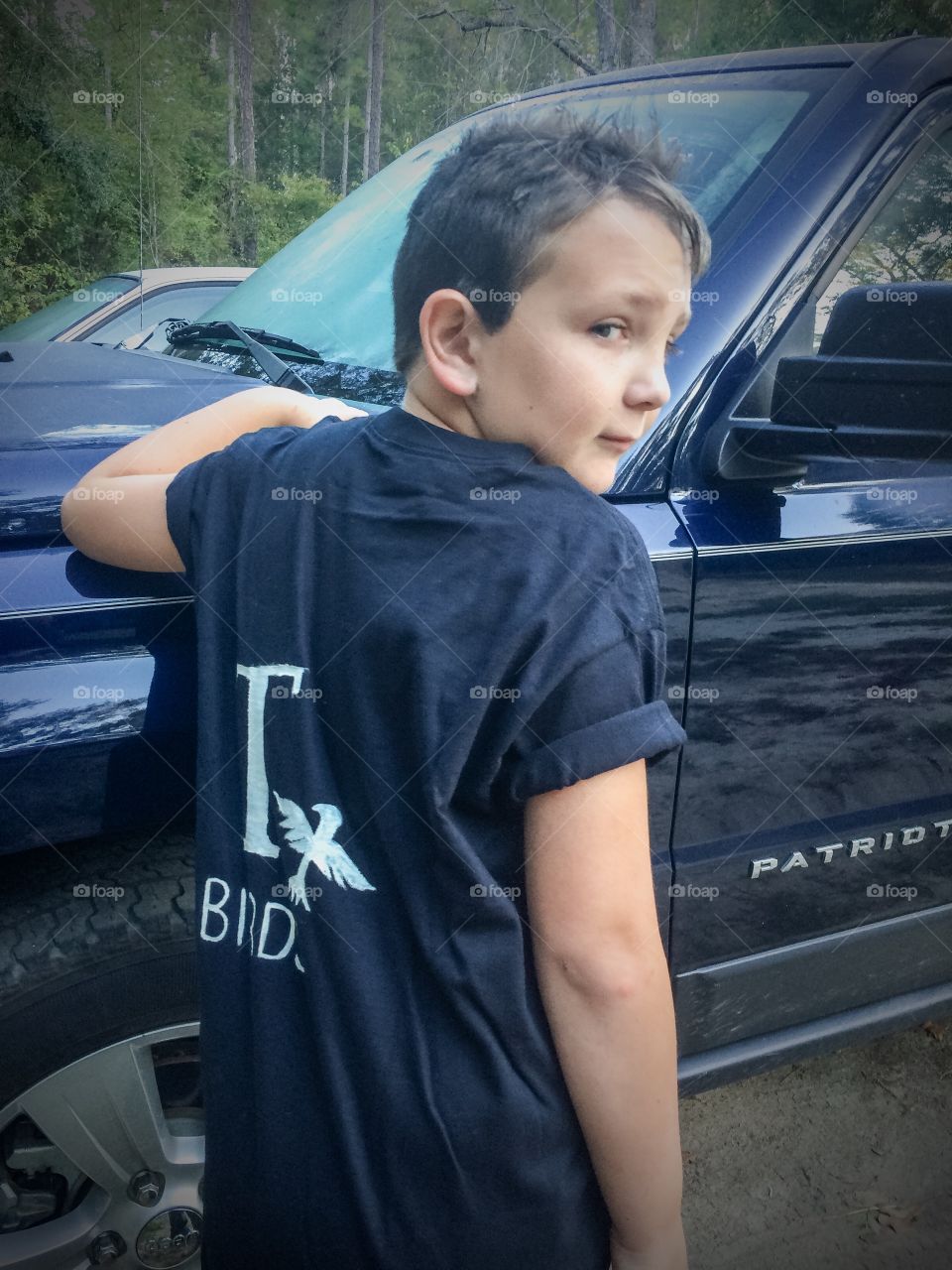 Boy posing near the car