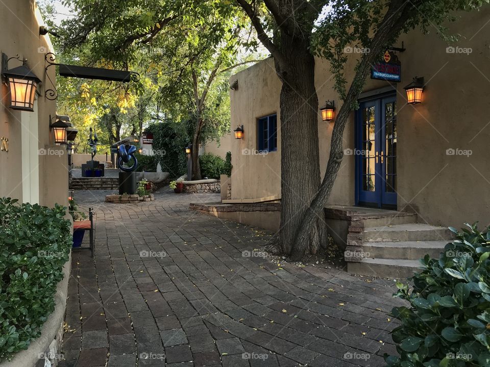 Courtyard off Canyon Road in Santa Fe, New Mexico, with sculptures and lanterns
