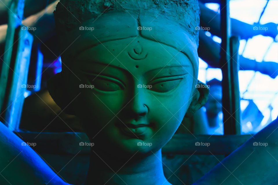 Handmade clay model of "Maa Durga" or " Devi Durga"- Hindu woman Idol close up. Snapped in the beginning of city famous Bengali festival of Kolkata or Calcutta, West Bengal, India, Asia