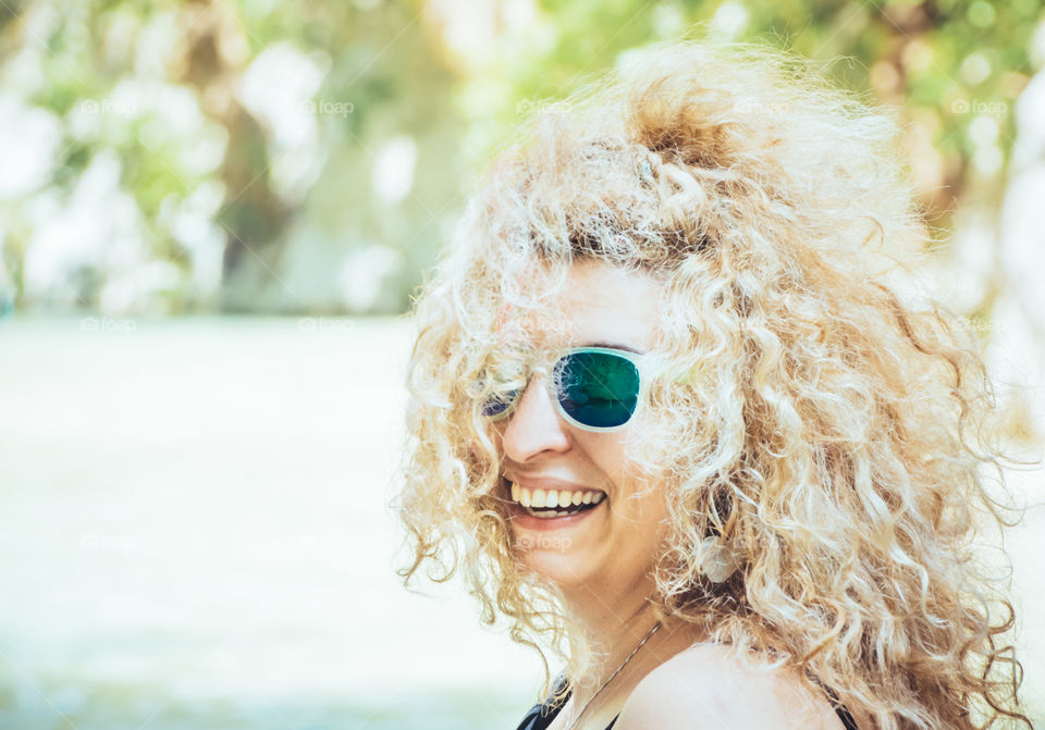Happy Blonde Woman With Sunglasses On Vacation
