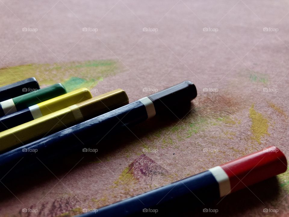 Closeup of color pencils on drafting table 