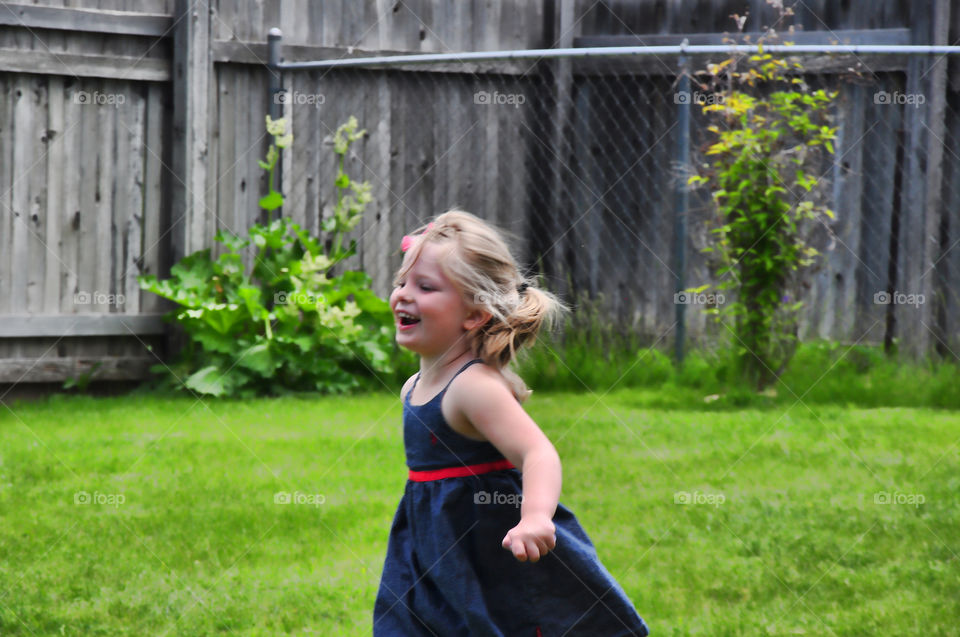 Running Girl. Granddaughter playing in back yard