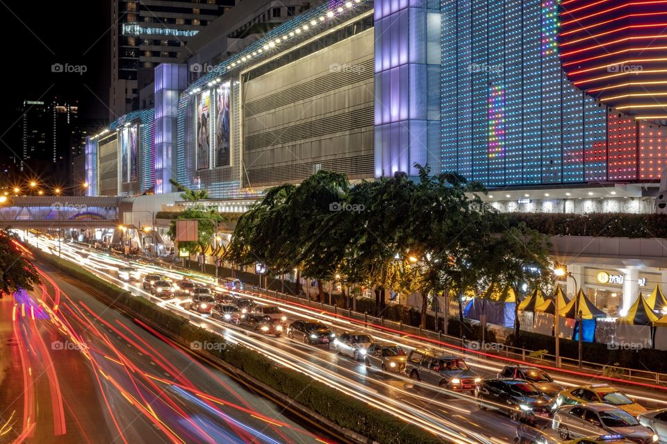 Beautiful Vehicle headlamp light at U turn road in front of the most famous shopping center MBK , Bangkok Thailand