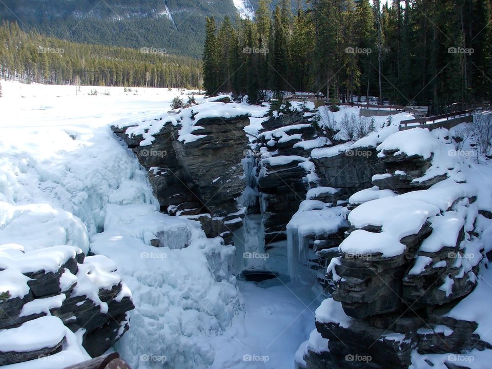 An image of the Athabasca Waterfalls in Jasper National Park during winter time. Frozen but still a picture of nature at it's best.