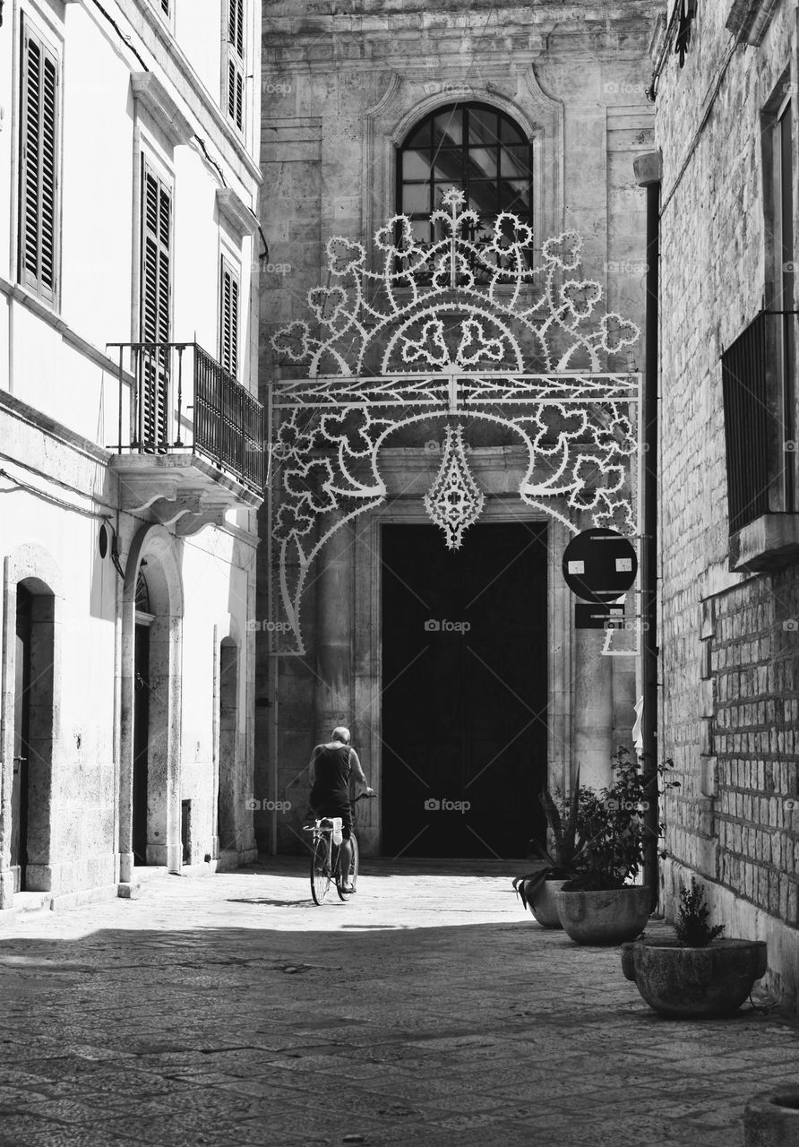 Men ride a bike in the city