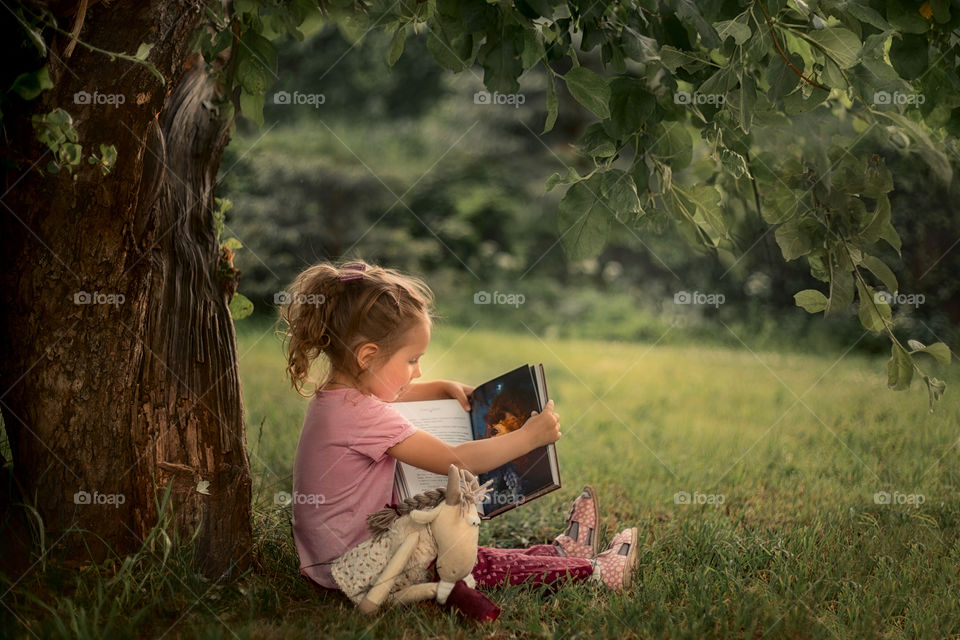 Girl reading the book outdoor