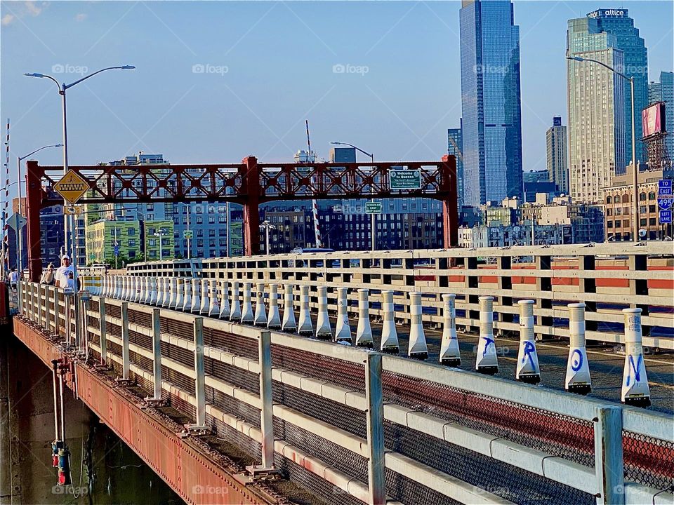 This elegantly streamlined modern industrial composition comes to us from the „Pulaski Bridge“ at „Newtown Creek“ walking in the pedestrian lane from „Greenpoint“, Bklyn to LIC, Queens during the golden hour of sunset. 2023 Hypnotic Productions