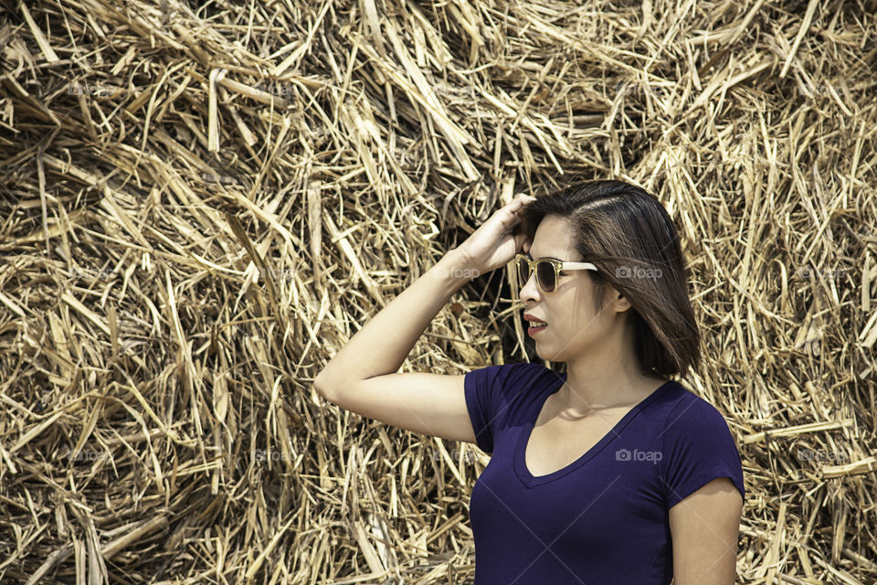 Portrait of Asian women Background pile of stacked straw