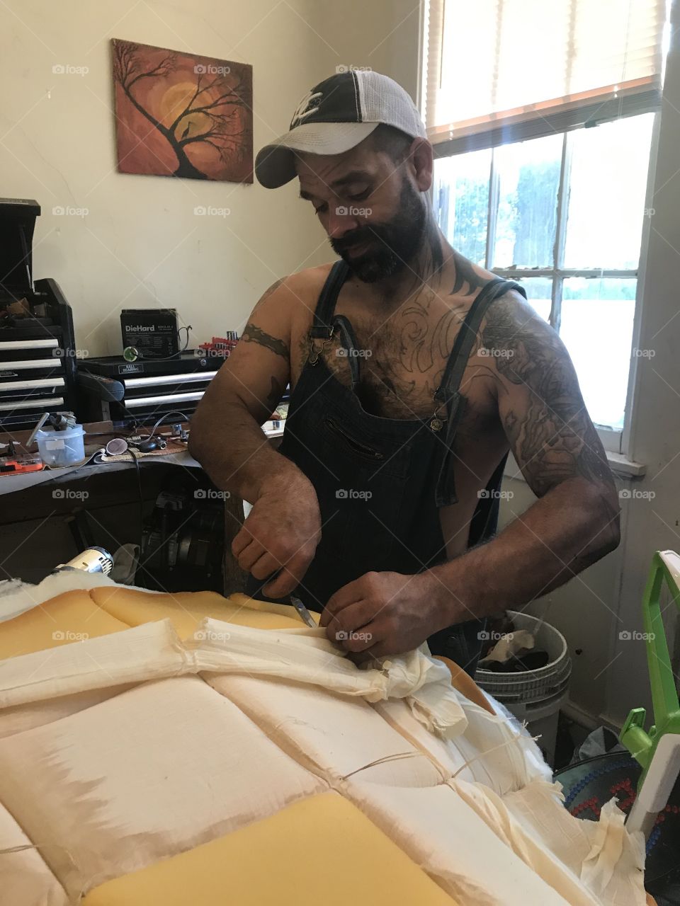Man working on reupholstering chase lounge