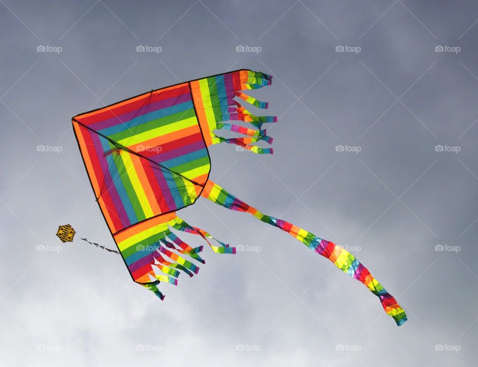 flying kite in the sky in rainbow colours