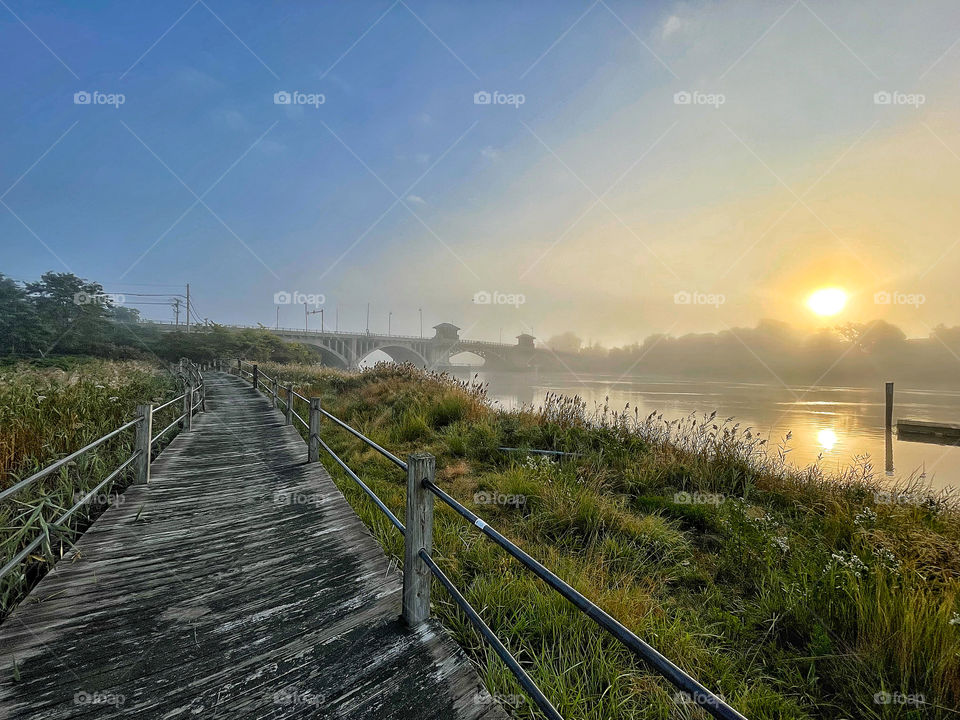 Foggy sunrise on the housatonic riverbank  