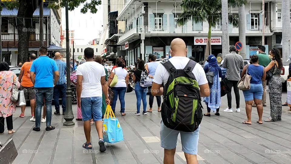 Crowd: People waiting to cross the road.