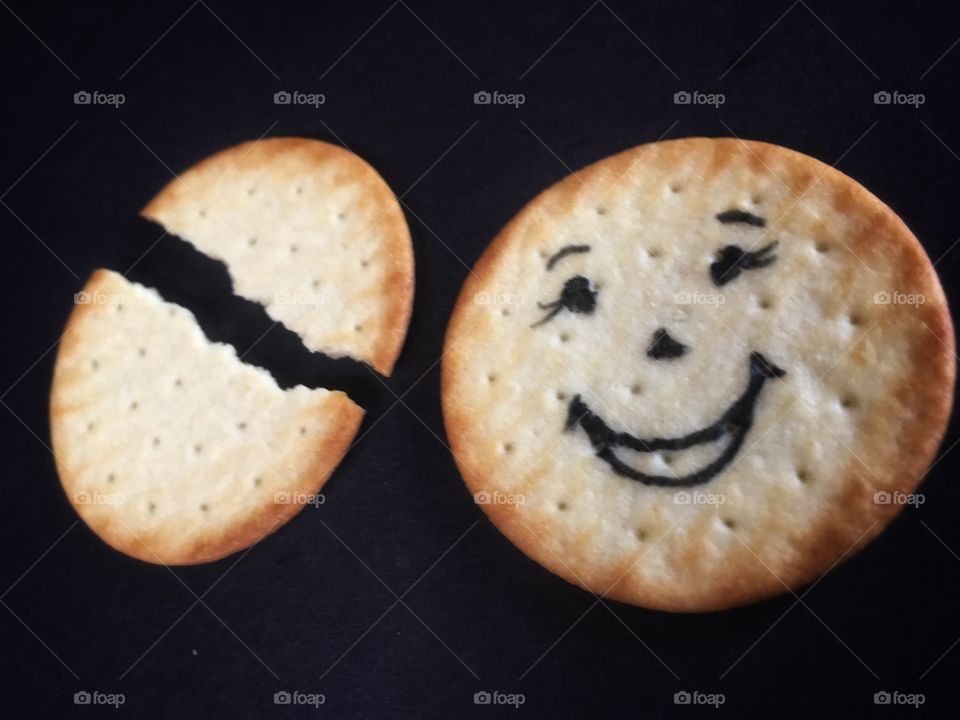 Smiling at broken biscuit 