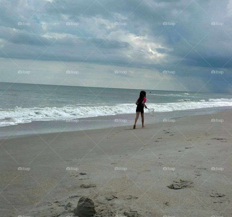 Little Girl on beach with net